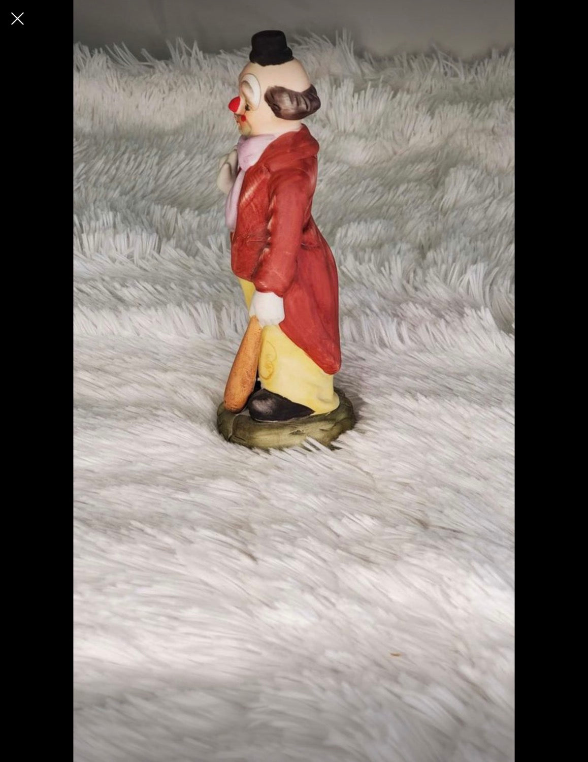 Clown statue with a baseball bat image 5