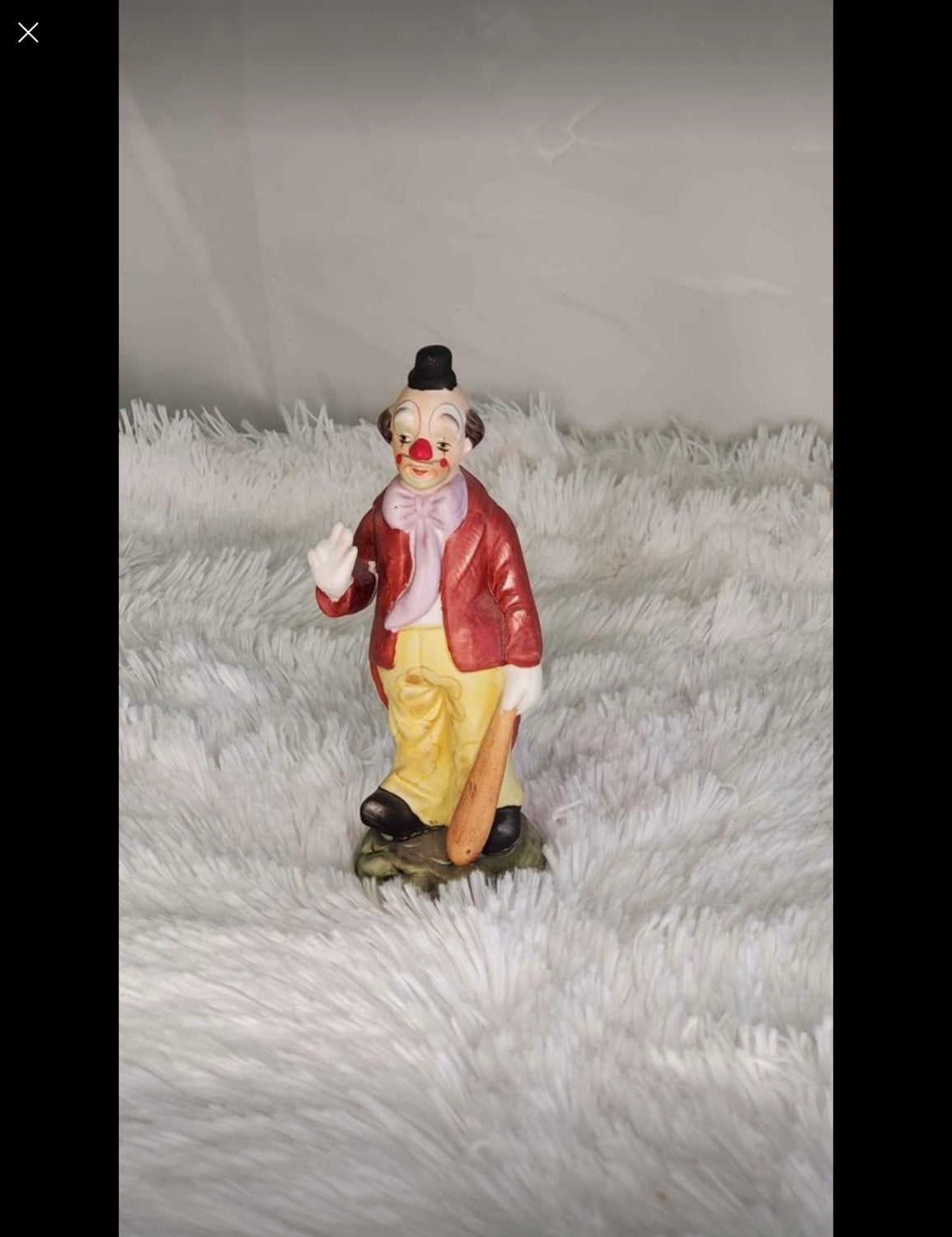 Clown statue with a baseball bat image 3